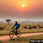 차드에서 자전거 여행 루트 - Cycling through the Vast African Savanna at Dawn**
A wide-angle, cinematic shot of a lone traveler o...